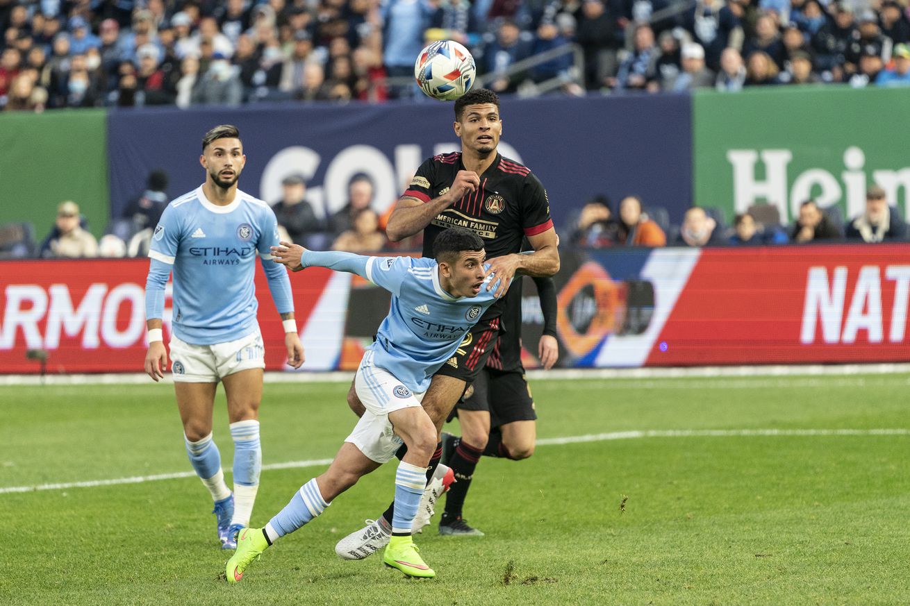 Santiago Rodriguez (42) of NYCFC and Miles Robinson (12) of...