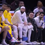 Jan 23, 2024; Los Angeles, California, USA; Los Angeles Lakers guard Jalen Hood-Schifino (0) and guard Austin Reaves (15) and forward Rui Hachimura (28) and guard Max Christie (10) forward Anthony Davis (3) and forward LeBron James (23) look on from the bench in the second half against the Los Angeles Clippers at Crypto.com Arena. Mandatory Credit: Jayne Kamin-Oncea-USA TODAY Sports