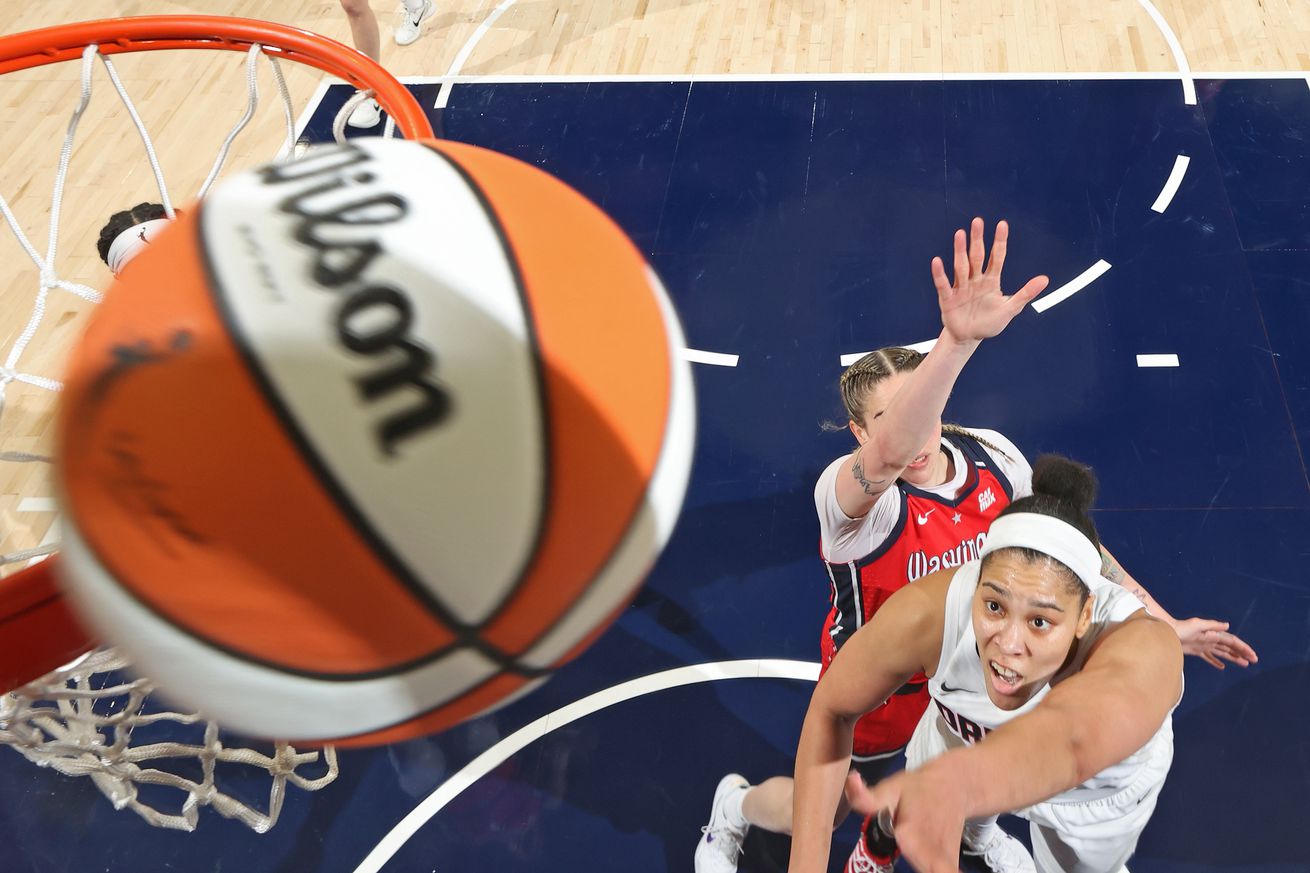 Brionna Jones shoots at the rim with a defender on her in the Atlanta Dream preseason game against the Washington Mystics
