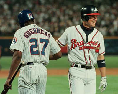 Chipper Jones(R) of the Atlanta Braves is congratu