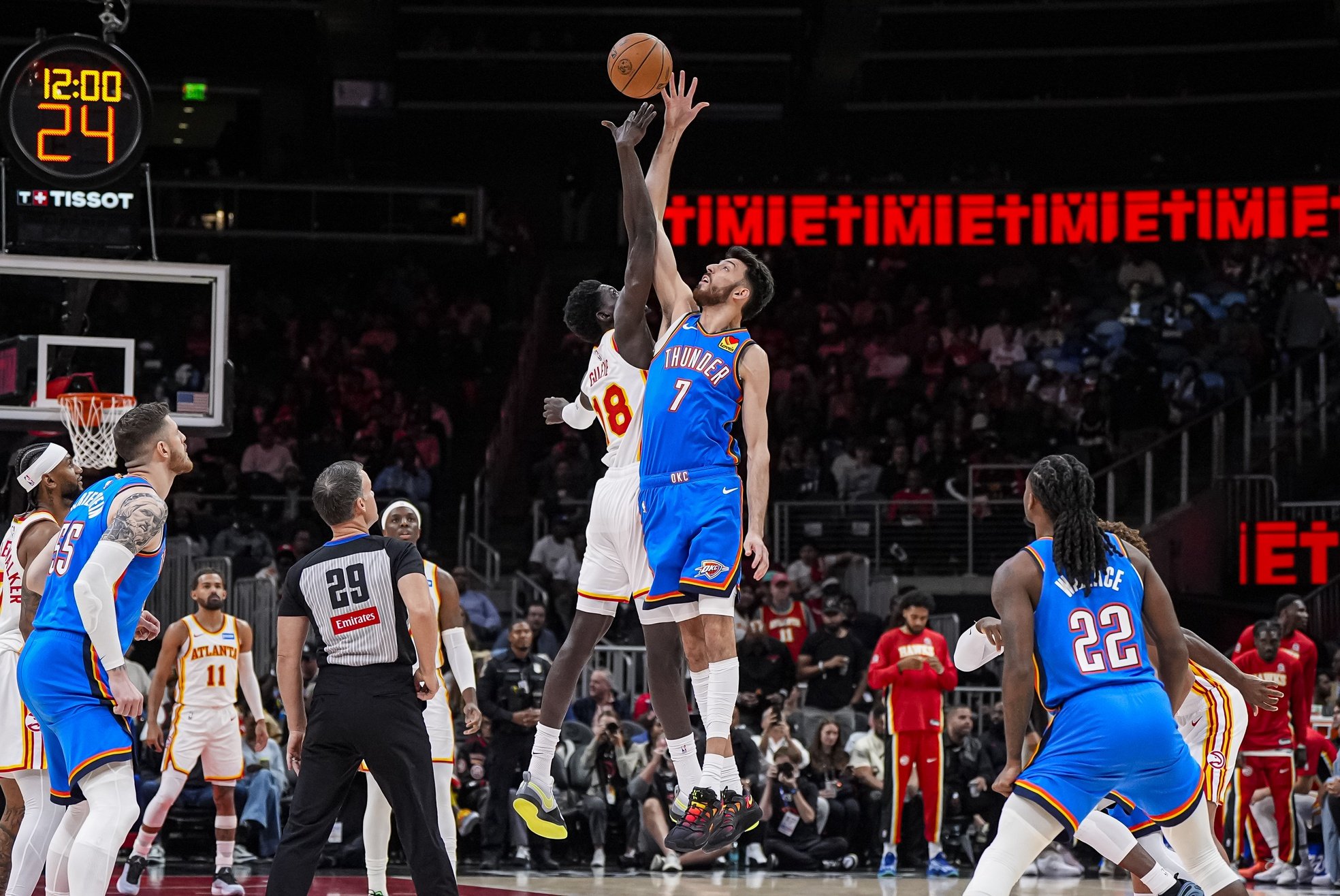 Atlanta Hawks forward Mouhamed Gueye (18) and Oklahoma City Thunder center Chet Holmgren (7) reach for the opening tip off