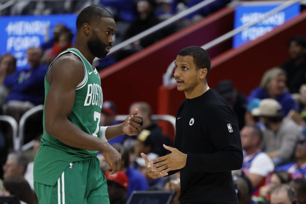 Boston Celtics head coach Joe Mazzulla speaks to Celtics star Jaylen Brown as he heads to sideline