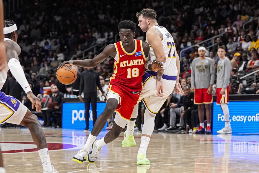 Atlanta Hawks forward Mouhamed Gueye (18) dribbles against Los Angeles Lakers guard Luka Doncic (77) during the second half at State Farm Arena.