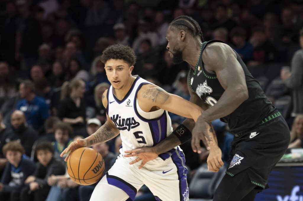 Sacramento Kings guard Nique Clifford (5) dribbles the ball past Minnesota Timberwolves forward Julius Randle (30) in the second half at Target Center.