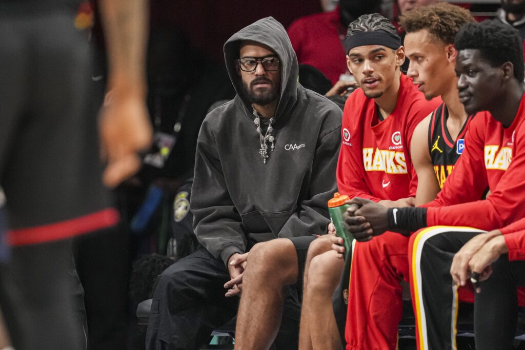 Dec 31, 2025; Atlanta, Georgia, USA; Atlanta Hawks injured player Trae Young (center in hoodie) on the bench during the game against the Minnesota Timberwolves during the second half at State Farm Arena. Mandatory Credit: Dale Zanine-Imagn Images